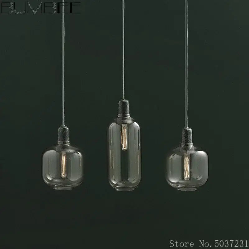 Industrial stained glass pendant light set with three frosted clear filament bulbs hanging by black cords for dining room decorbites industrial stained