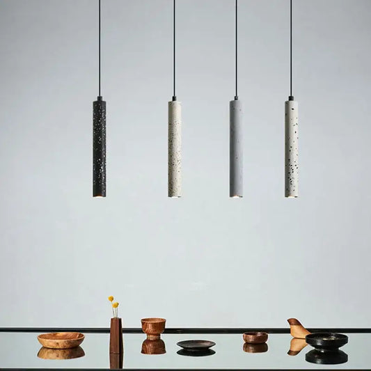 Four minimalist pendant lamps with speckled concrete finish and black cords from decorbites industrial stone led collection