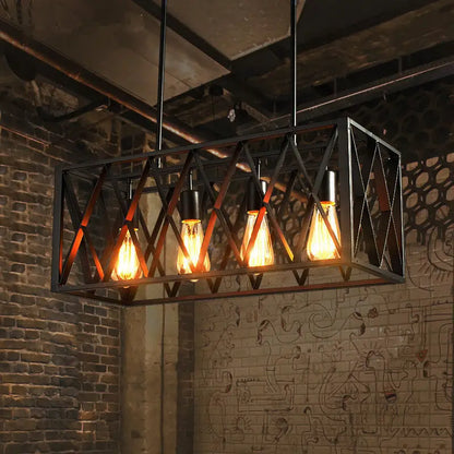 Industrial style black ironwork rectangular island light with four glowing filament bulbs for kitchen use