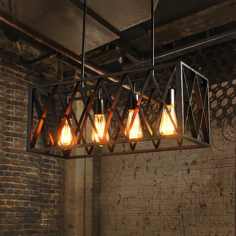 Industrial style black ironwork rectangular island light with four glowing filament bulbs for kitchen use