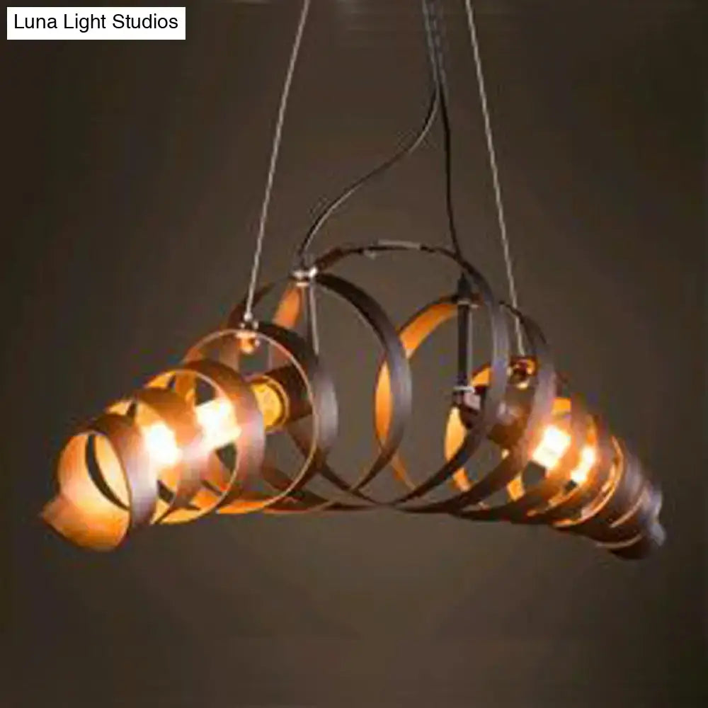 Industrial style dark bronze spiral metal pendant light with multiple concentric rings and warm glowing bulbs for dining room