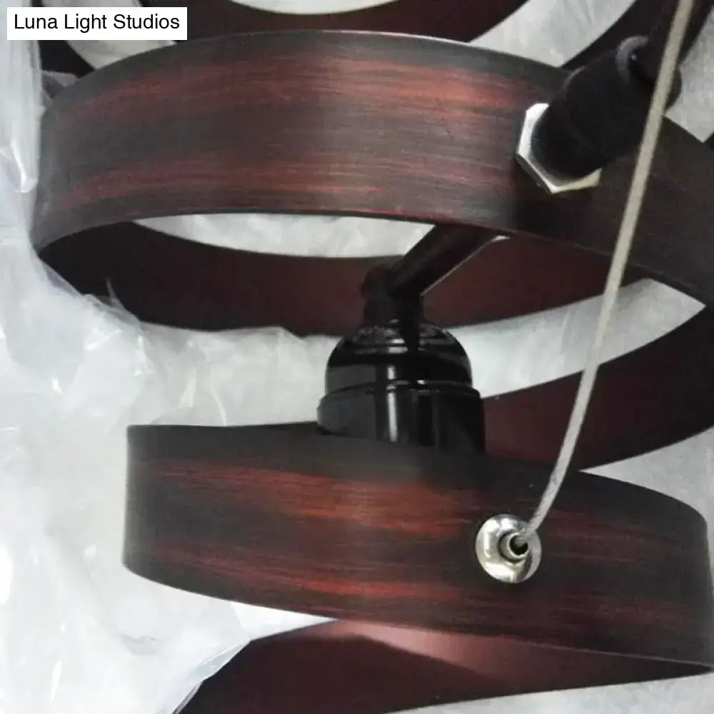 Industrial style dark bronze spiral metal pendant light with dark wood finish and silver hardware for dining room