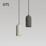 Two minimalist pendant lights in matte white and dark gray concrete with black cords in decorbites industrial style led chandelier