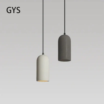 Two minimalist pendant lights in matte white and dark gray concrete with black cords in decorbites industrial style led chandelier