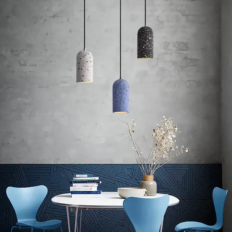 Three cylindrical industrial terrazzo cement pendant lights in white blue and black hang for kitchen and dining decorbites cement pendant lighting