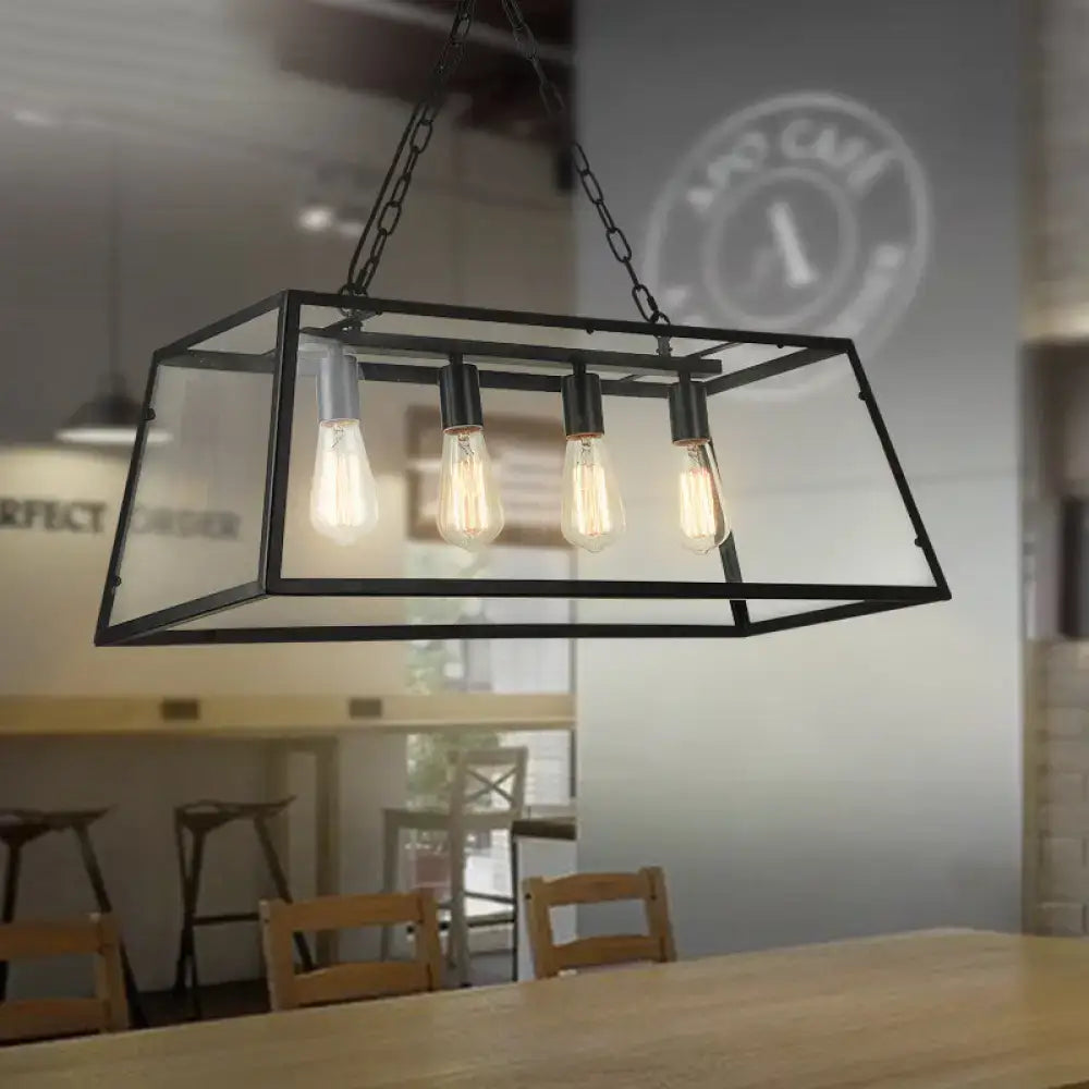 Black metal and clear glass industrial trapezoid island lamp with four exposed filament bulbs and chain downrods