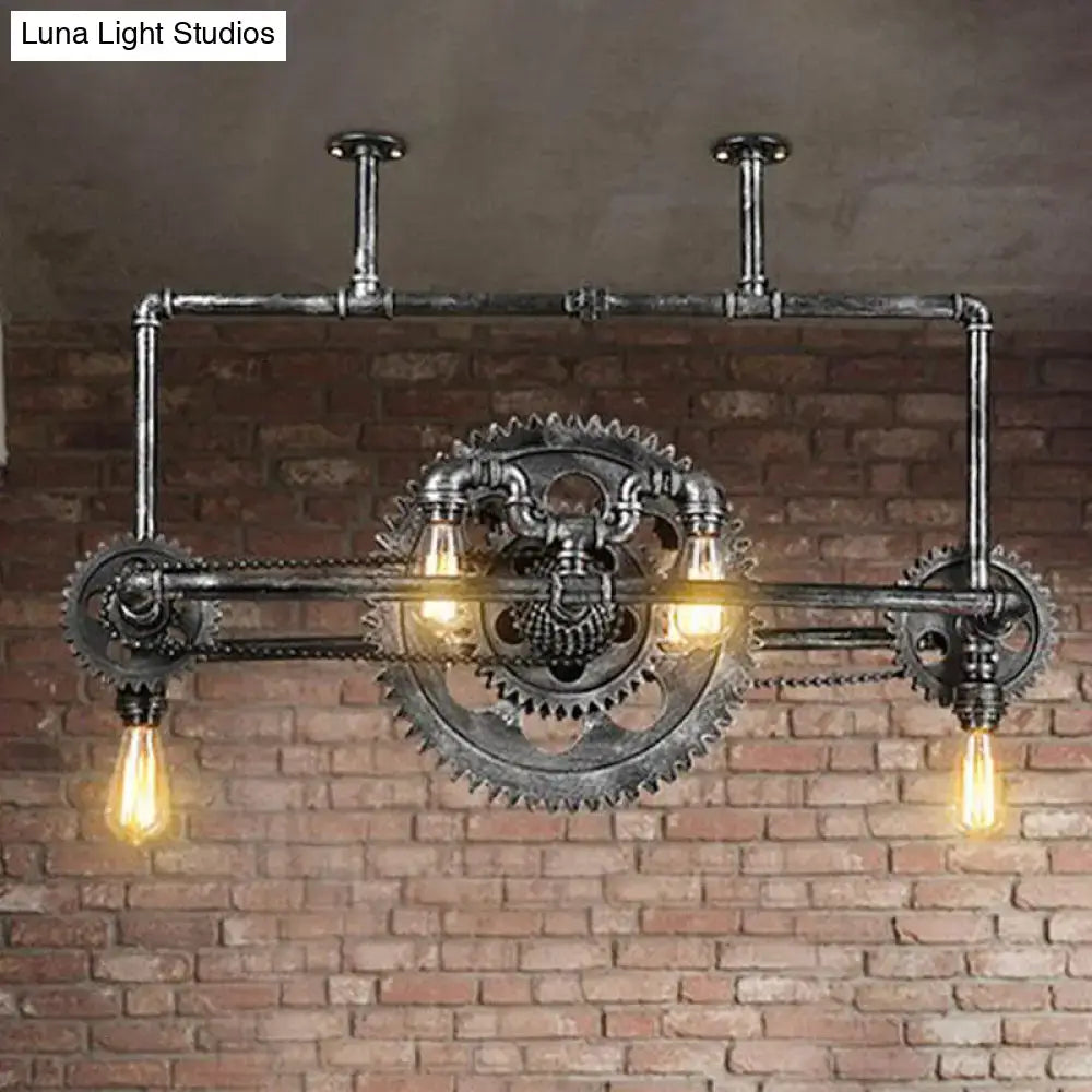 Industrial vintage black gear chandelier with dark metallic finish and exposed edison bulbs for dining room lighting