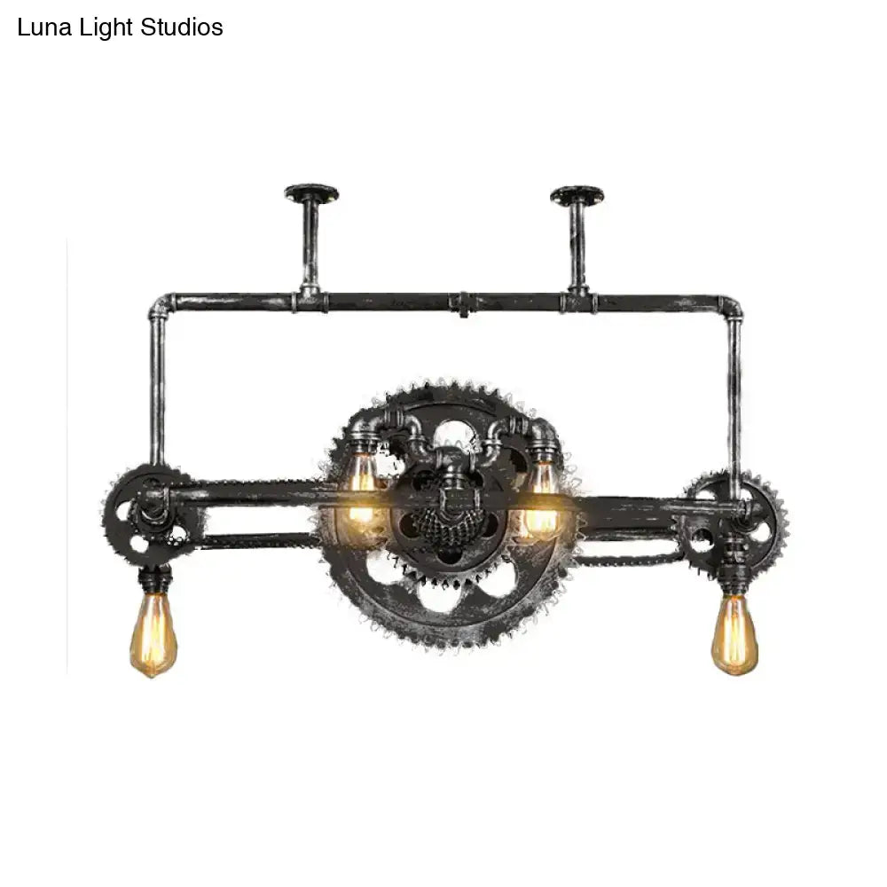 Industrial vintage black gear chandelier with dark rustic metal frame and three amber filament bulbs for dining room