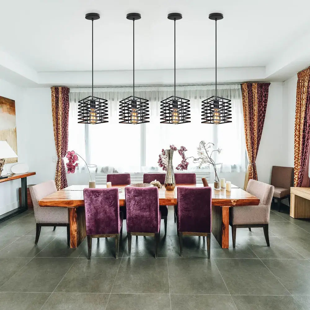 Four black metal cage pendant lights hang above a dining table in a decorbites industrial vintage led set