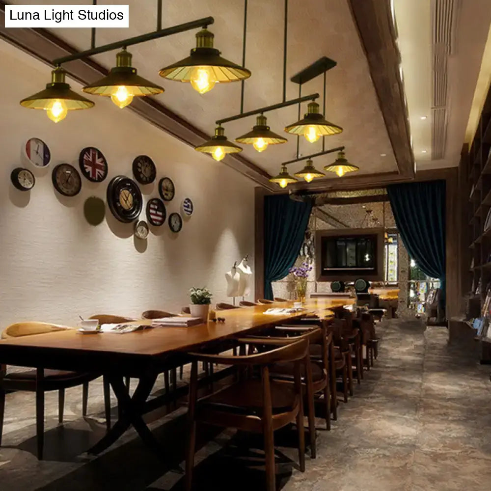 Vintage brass pendant lights with warm led incandescent bulbs hang above a wooden table for restaurant use