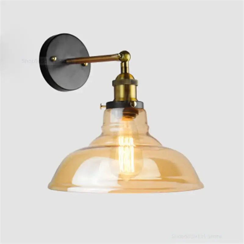 Industrial vintage loft wall lamp with brass arm black mount amber glass shade and exposed filament bulb decorbites industrial vintage