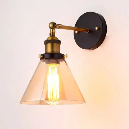 Industrial vintage loft wall lamp with brass arm black mount and translucent amber glass shade by decorbites industrial vintage