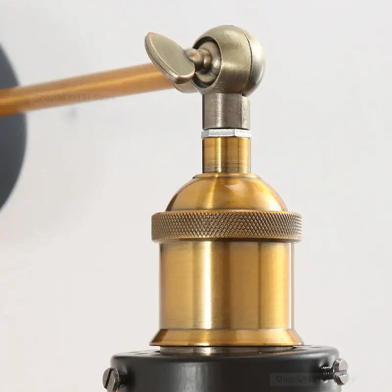 Brass-finished industrial vintage loft wall lamp with knurled collar and adjustable arm featuring clear and amber glass