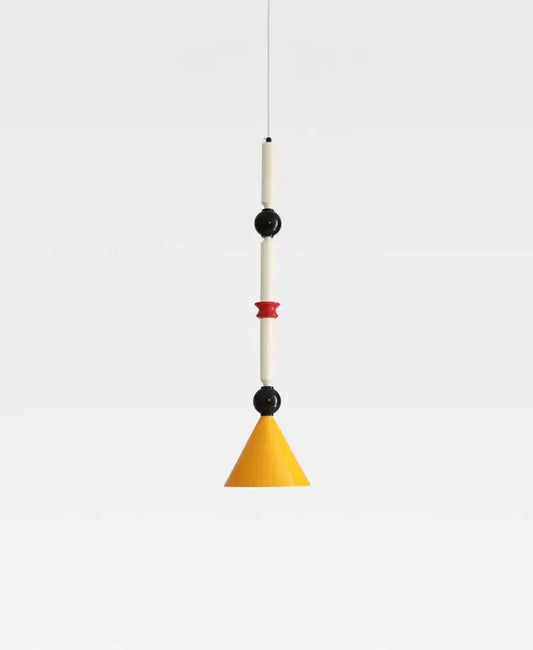A modern industrial vintage pendant light with yellow conical shade, white cylinders, and black spherical accents by decorbites