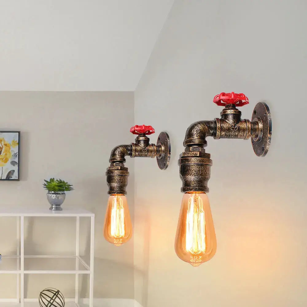 Industrial water pipe wall sconce kitchen light with brass finished pipes red valve handles and glowing amber edison bulbs