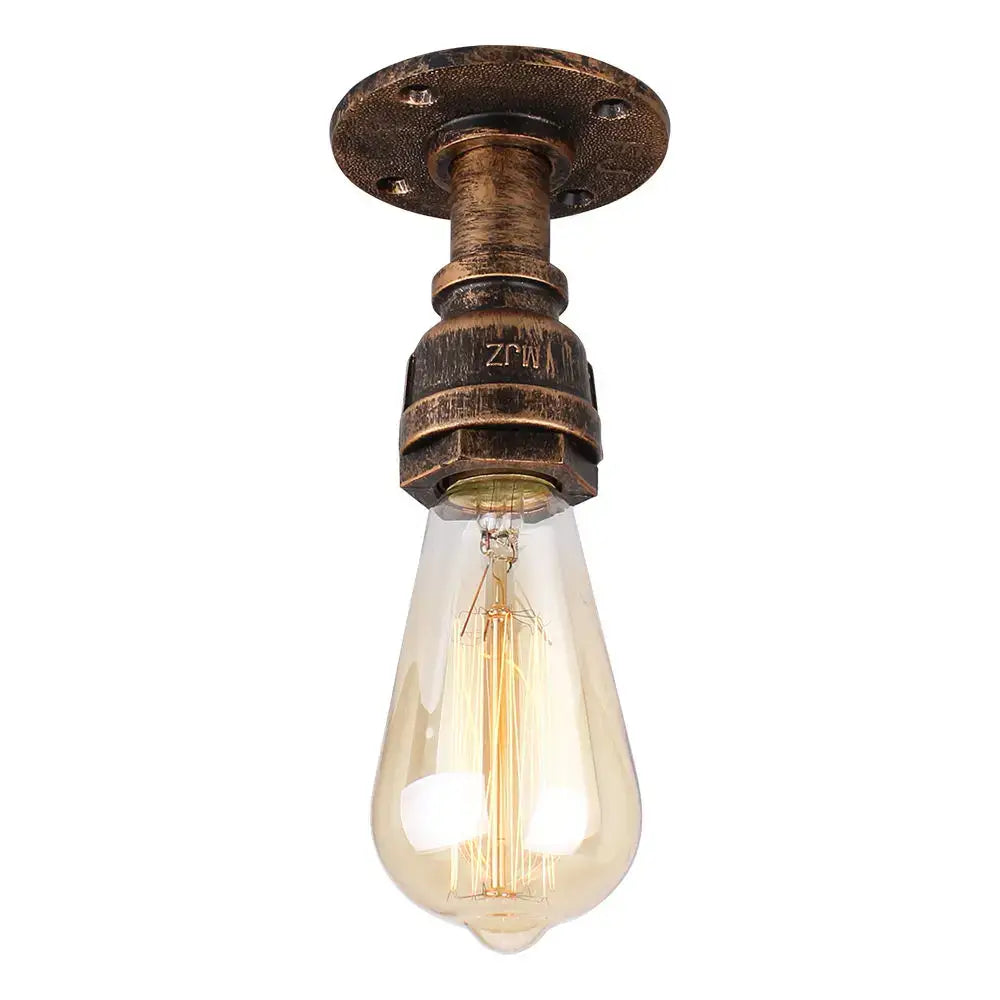 Industrial water pipe wall sconce kitchen light in black brass with bronze metal fixture and amber glass bulb by decorbites