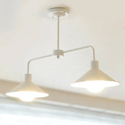 White industrial-style DecorBites pendant light with two conical shades and curved angle arm for kitchen island lighting