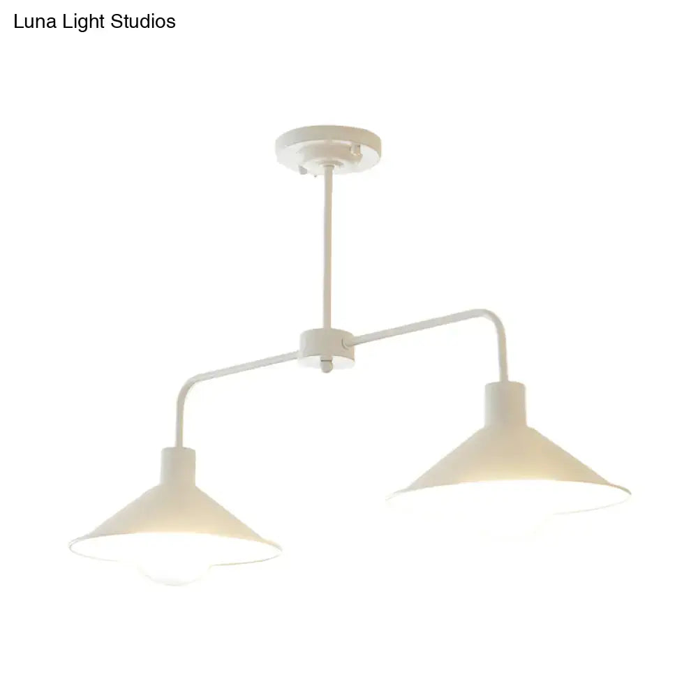 White industrial-style pendant light with two conical shades and angle arm for kitchen island lighting by DecorBites