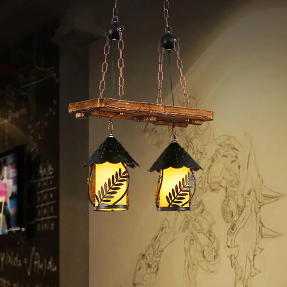 Industrial white clear wooden plank with black leaf-patterned lantern island lighting for dining room use