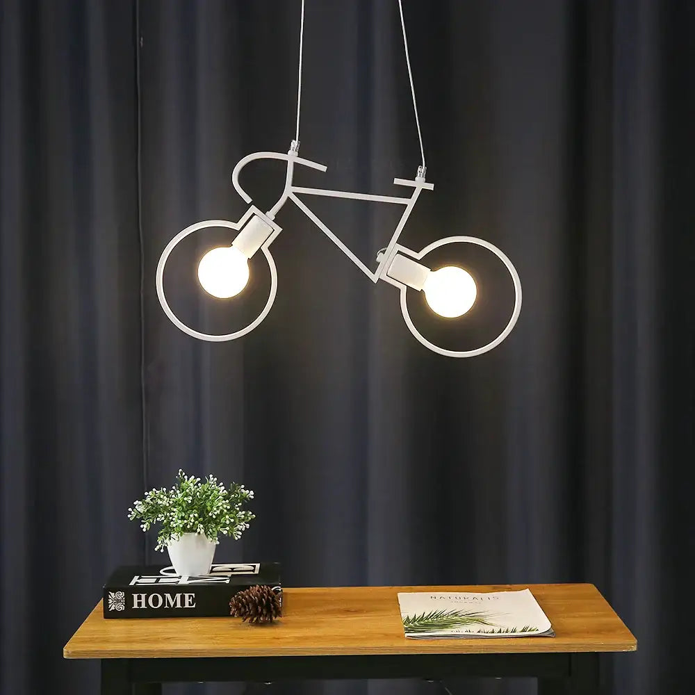 White metal iron bicycle pendant light with two glowing bulbs for industrial living room decor by decorbites