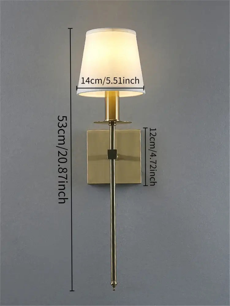 Brass-finished wall lamp with cylindrical stem and off-white fabric shade from decorbites industrial white wall collection