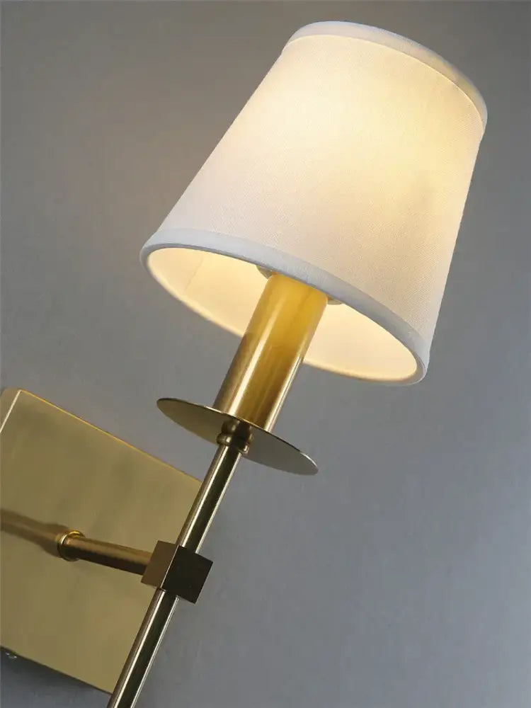 A brass finish industrial white wall lamp with a soft white fabric shade for bathroom decorbites industrial white design