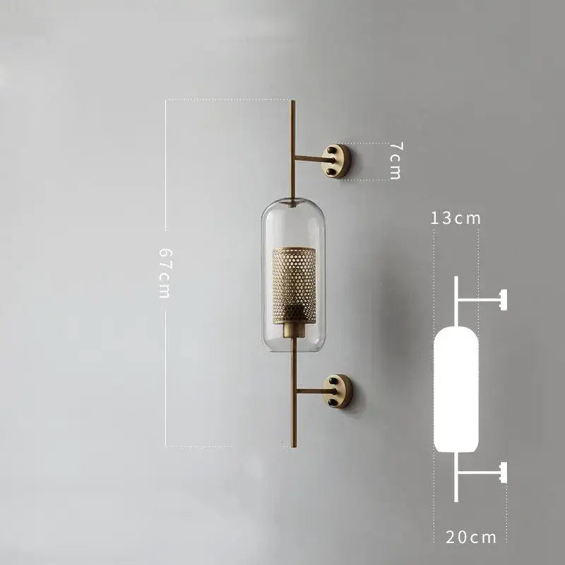 Brass-finished wall lamp with clear glass cylinder and perforated metal center element decorbites industrial wind grid design