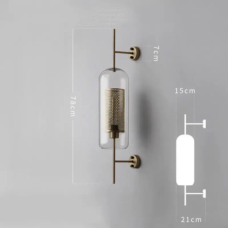 Brass-finished industrial wind grid wall lamp with clear glass cylinder and intricate mesh interior for living room decorbites industrial wind