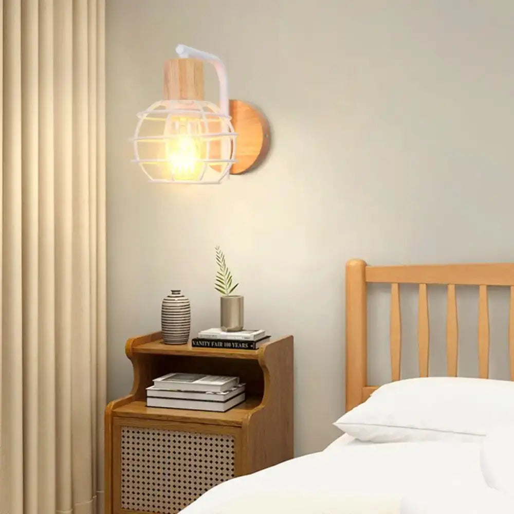 Warm-toned wall sconce with white metal cage wooden base and arm decorbites industrial wire cage bedroom light fixture