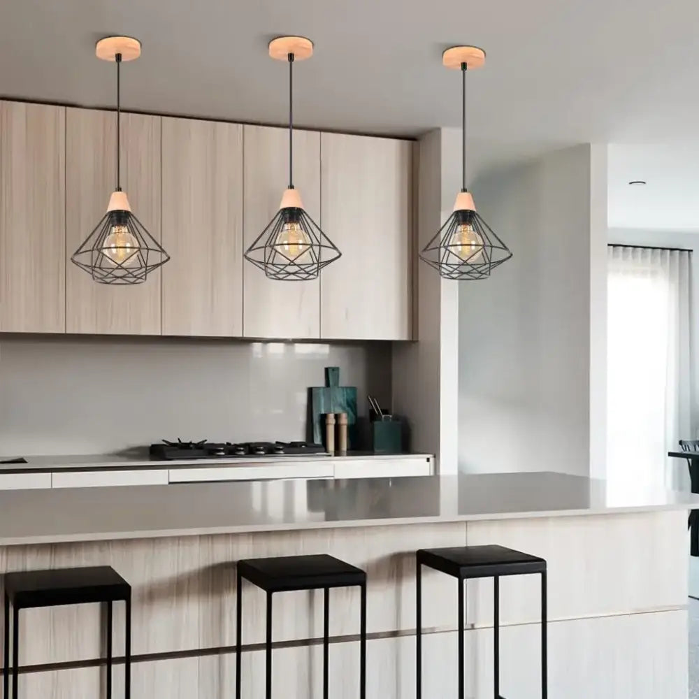 Three black metal cage industrial wood ceiling chandelier pendant lights with wooden caps above kitchen island decorbites industrial wood