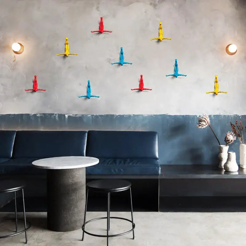Vibrant colorful plastic decorbites bungee jumper wall sculpture in red yellow and blue for living room decor