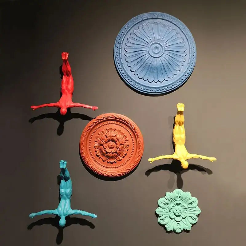 Industrial yellow bungee jumper wall sculpture featuring glossy resin human figures and ornate medallions for living room decorbites bungee jumper