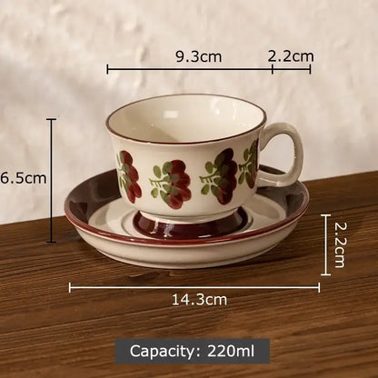 A white ink flowers ceramic cup and saucer set with red and green floral patterns and brown rim and base for dining room decor