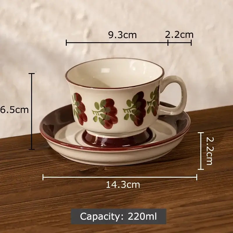 A white ink flowers ceramic cup and saucer set with red and green floral patterns and brown rim and base for dining room decor