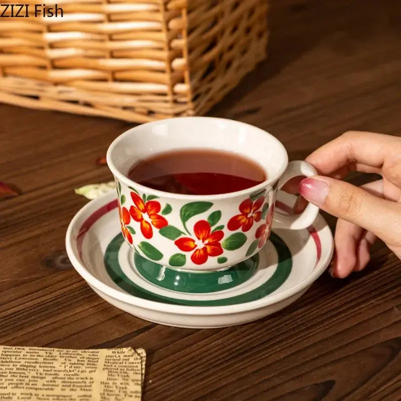 White ceramic flowers ceramic cup with red and green floral design on matching saucer from decorbites ink flowers set