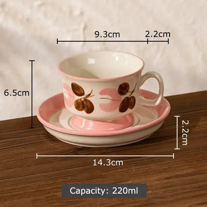 A delicate pink and white ink flowers ceramic cup and saucer set with brown coffee bean illustrations for dining room decorbites ink flowers