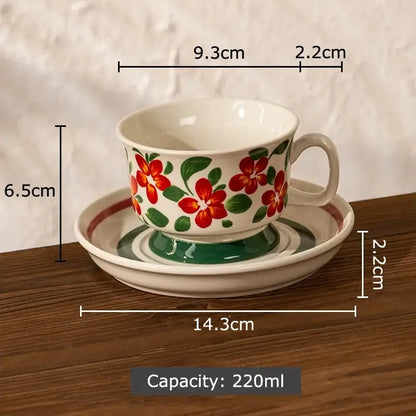 A white ceramic ink flowers ceramic teacup and saucer set with red floral pattern and green leaves for dining room decorbites