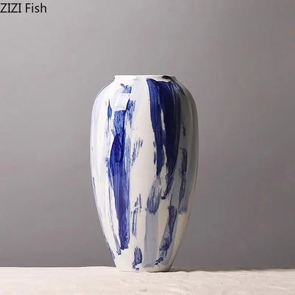 A white ceramic vase with bold abstract blue ink style brushstroke patterns for living room decor