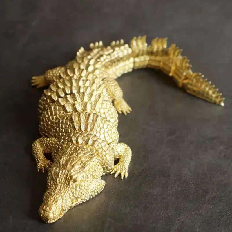 Intricate decorbites brass crocodile sculpture with detailed textured scales in golden brass for living room decor
