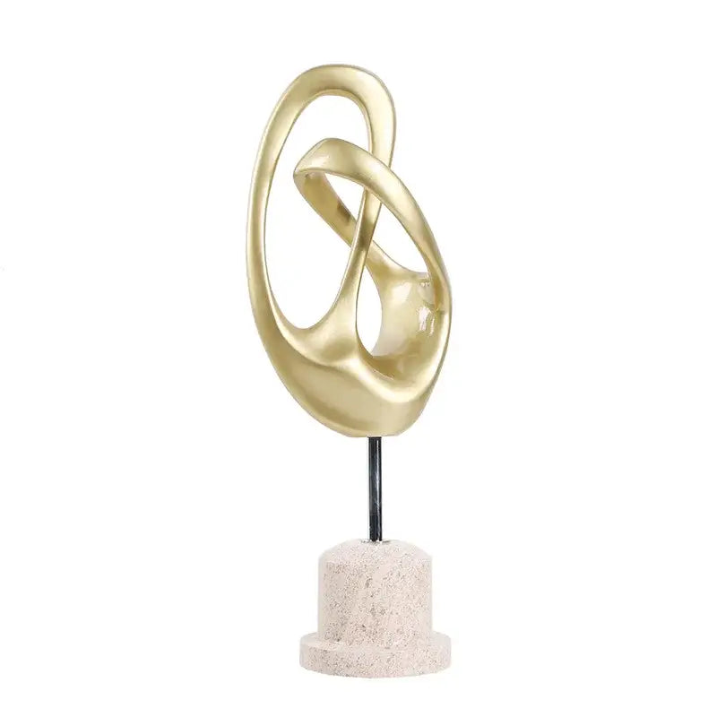 Intricate golden abstract metal horse decoration with flowing loops on textured stone base for living room display