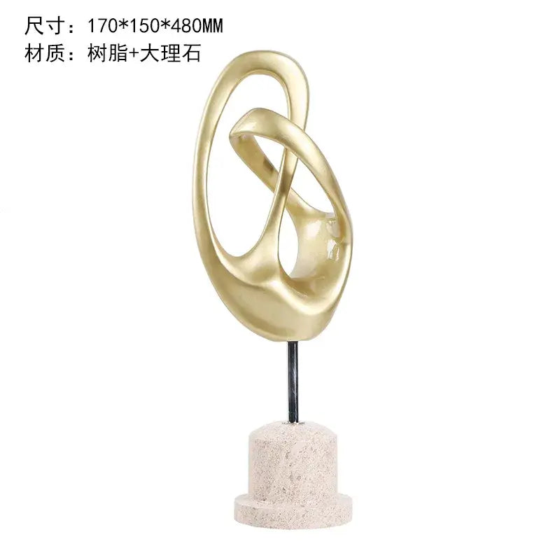 Intricate golden resin and marble abstract metal horse decoration with intertwined ovals on textured stone base for living room