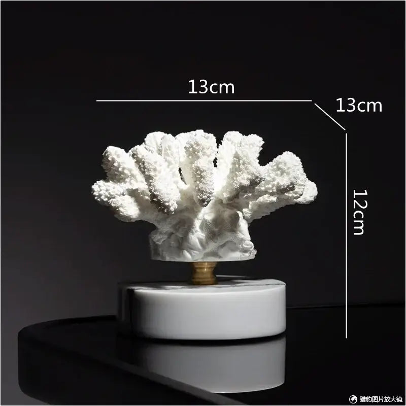 White coral resin ornaments with textured branching arms on a sleek white marble base for living room decor