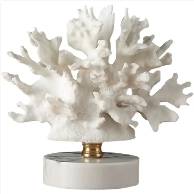 Intricate white coral resin ornaments with detailed branches mounted on marble base with gold-toned central stem