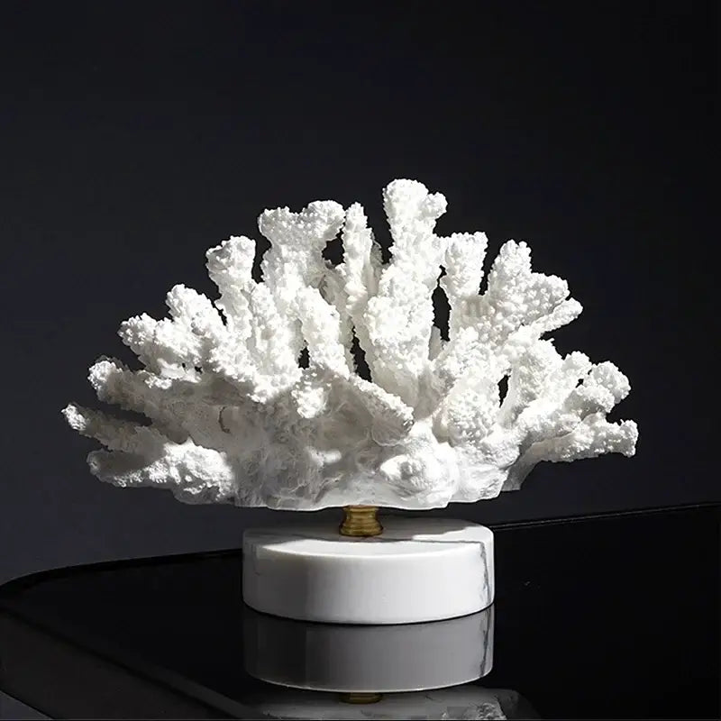 White coral resin ornaments with intricate branching texture on polished white marble base for living room decor