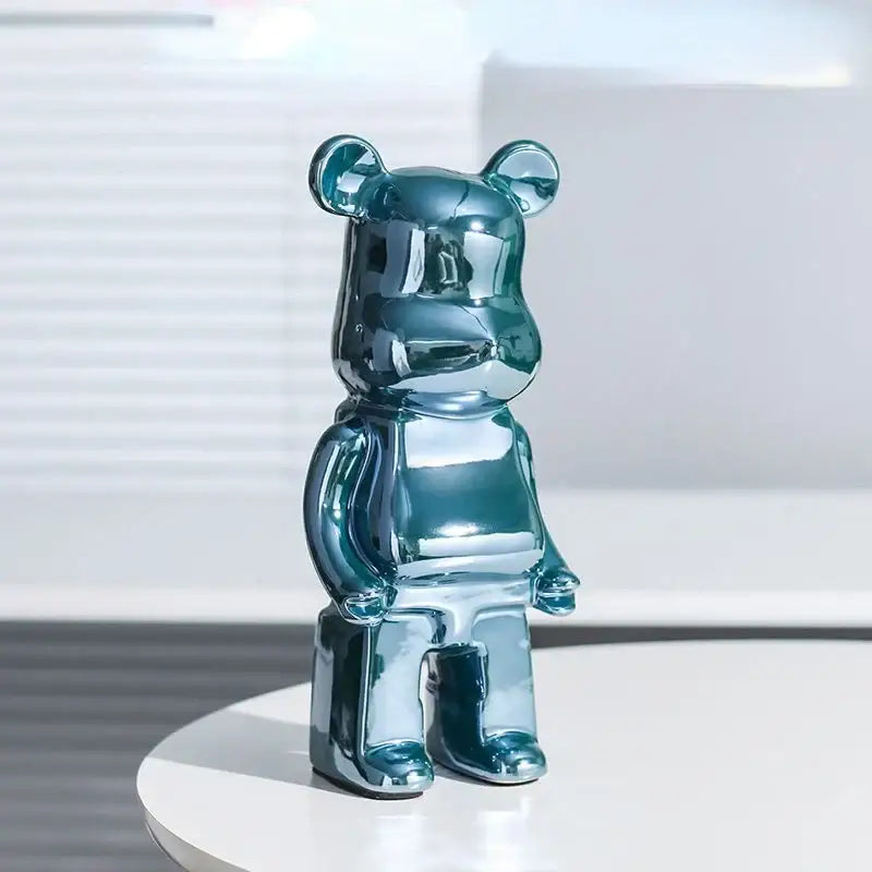 Shiny teal metallic bearbrick piggy bank with glossy reflective surface as iridescent cabinet sculpture decor