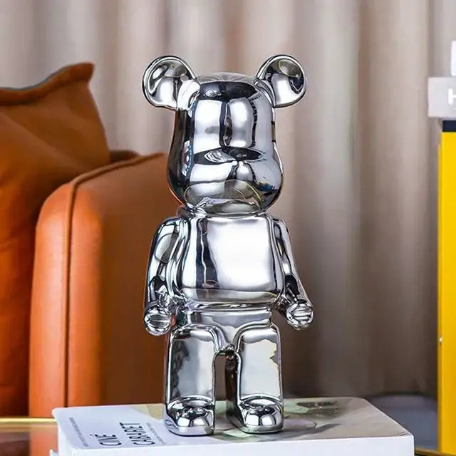 Shiny silver metallic bear piggy bank with glossy surface and rounded ears for iridescent bear tv cabinet sculpture decor