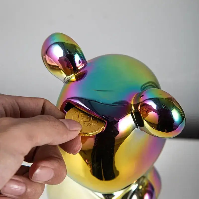 Iridescent metallic piggy bank with glossy rounded features and gold coin, ideal for bear tv cabinet sculpture decor or living room use