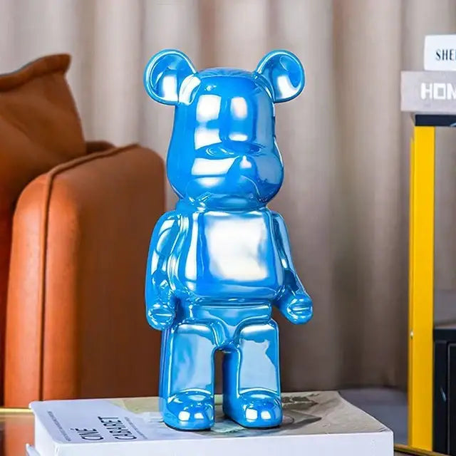A glossy blue translucent bearbrick piggy bank with a smooth reflective surface for cabinet sculpture decor