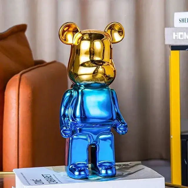 A glossy two-toned bear tv cabinet sculpture decor piggy bank with a golden head and blue body for living room
