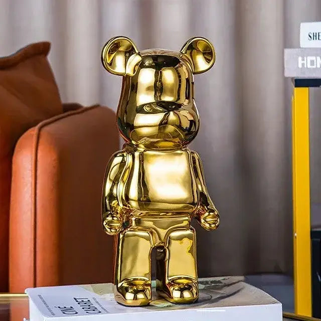 Shiny gold metallic bearbrick piggy bank with glossy reflective surface as cabinet sculpture decor for living room